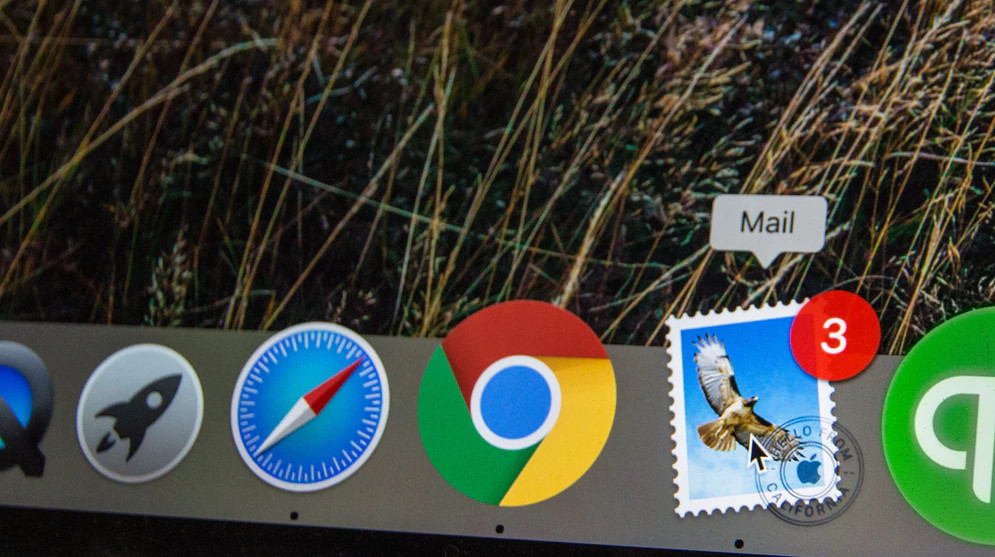 Photo of the task bar on a Mac computer showing icons, including the email icon