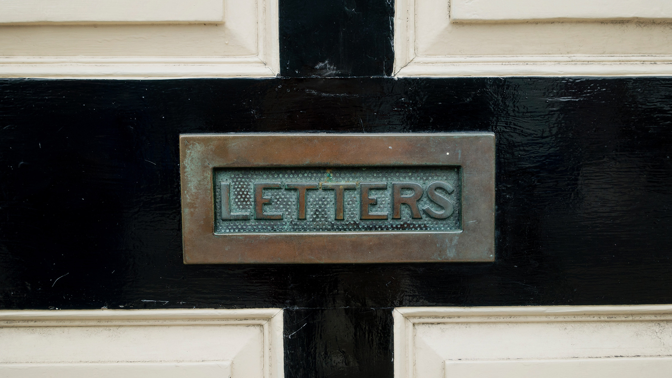 A letter slot in a door that says "Letters"