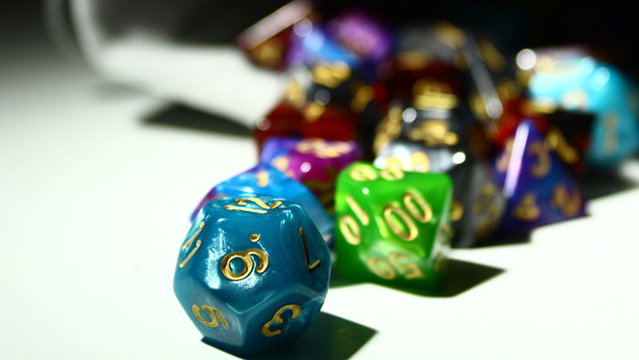 Multi-sided dice spilling out of a bag
