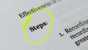 A piece of paper with text printed on it, including the word "Steps" which is highlighted with a yellow highlighter circle