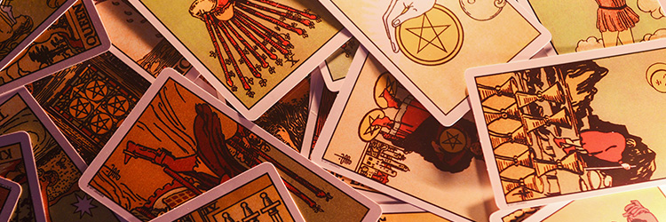Tarot cards scattered across a surface.